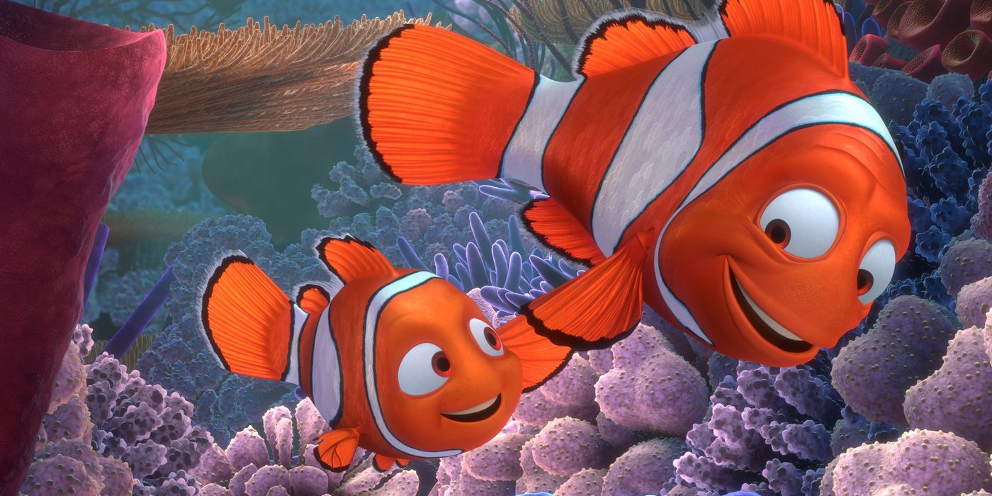 Marlin and Nemo smile at one another while holding fins in Finding Nemo