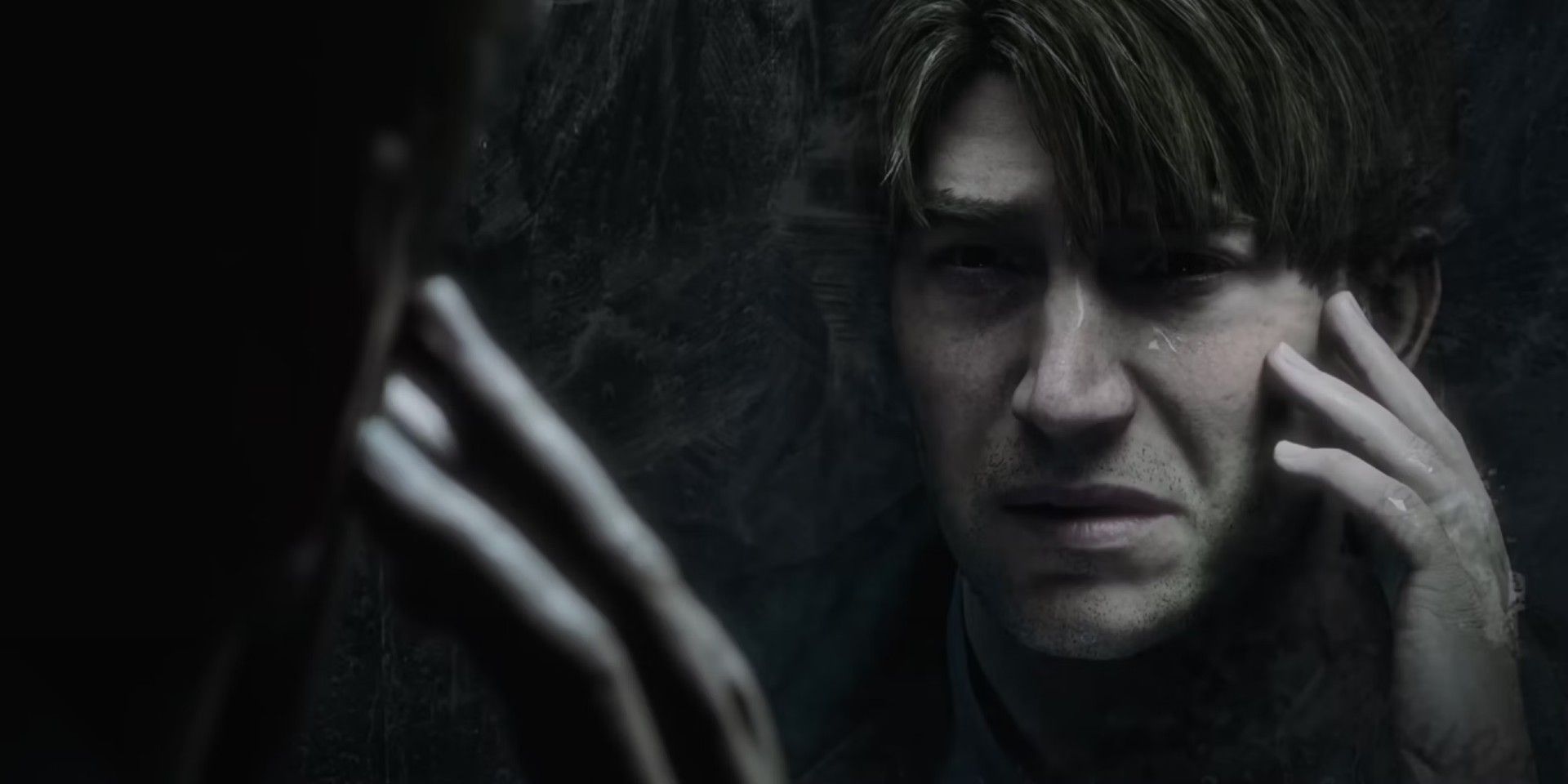 James looks at his reflection in the Silent Hill 2 remake.