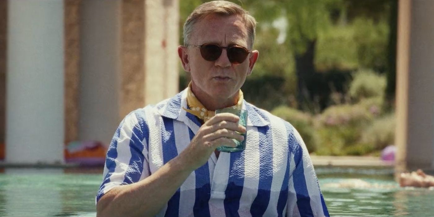 Daniel Craig's Benoi Blanc sits in the pool and has a drink in Glass Onion