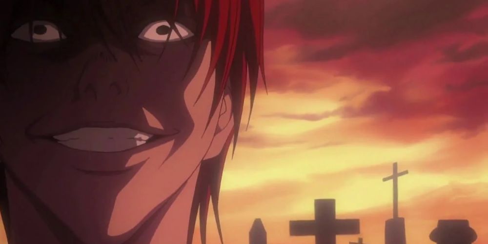 Light Yagami laughs at L's funeral in Death Note.