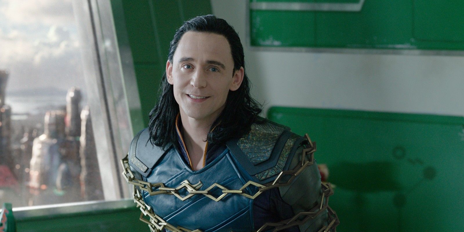 Loki smiling while being chained up