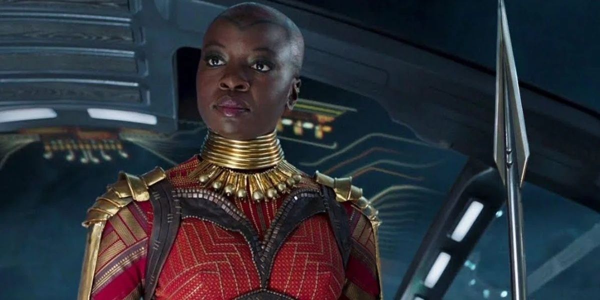 Okoye holding a spear by her side