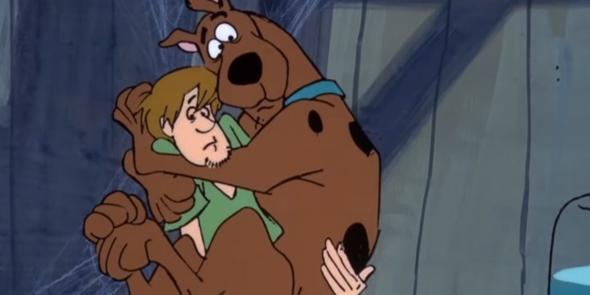 Shaggy holding Scooby after he had been frightened.