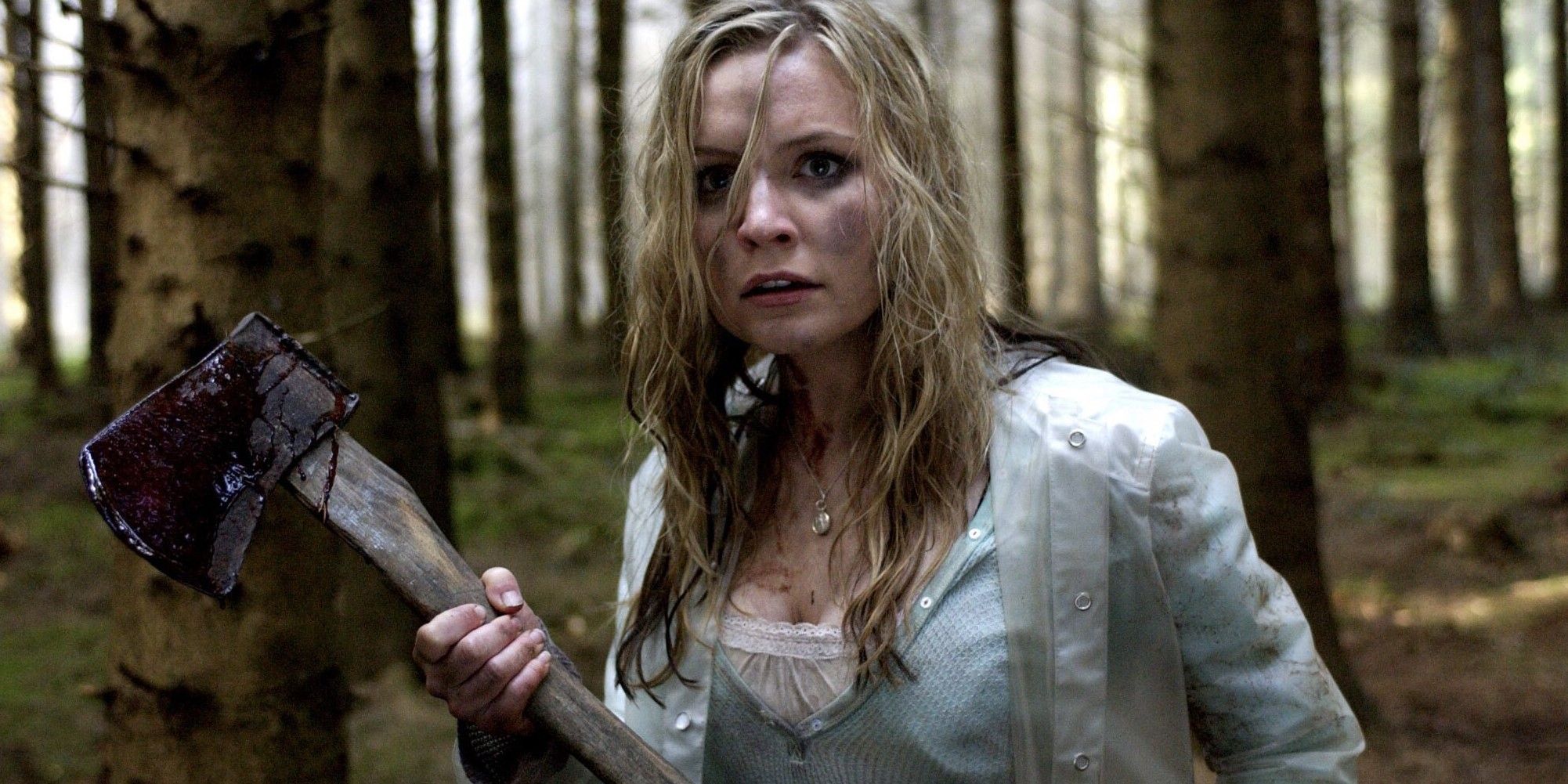 Tara wielding an axe in the forest in Shrooms movie.