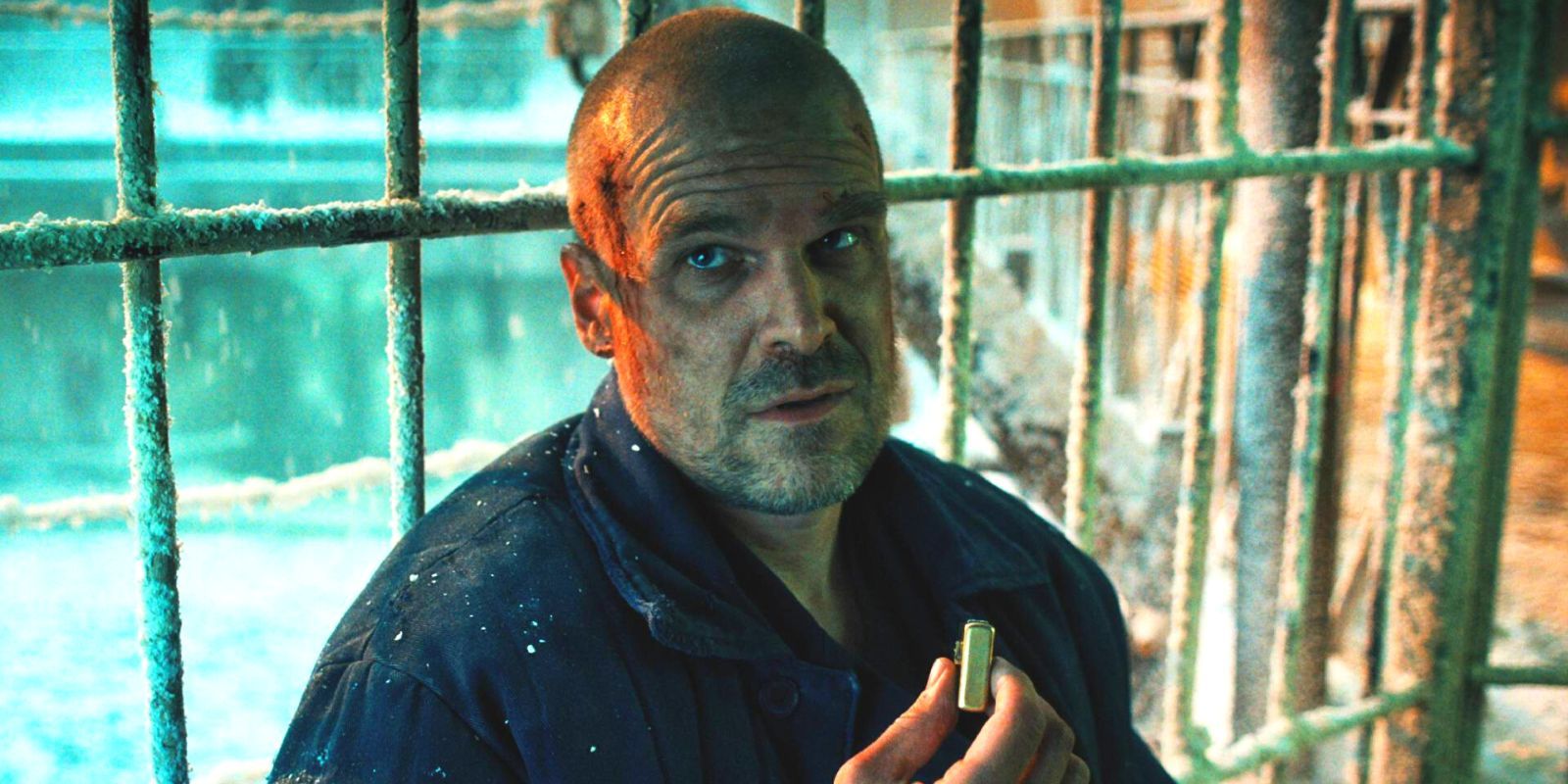 Stranger Things Season 4's Hopper in a snowy prison, holding a lighter