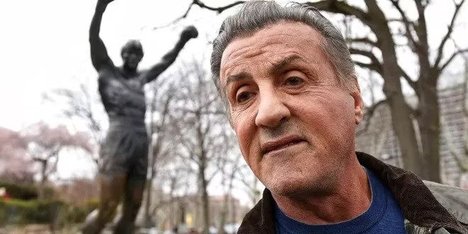 Sylvester Stallone in front of Philadelphia's Rocky statue