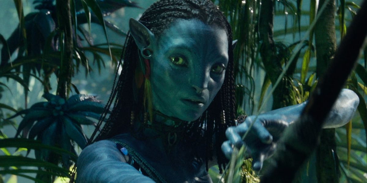 Neytiri, played by Zoe Saldana, brandishes a bow and arrow in Avatar: The Way of the Water