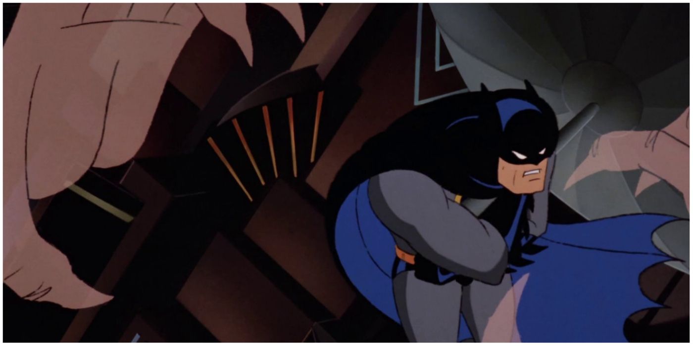 Batman holding onto the side of a blimp with ghostly hands closing in on him in Batman the animated series