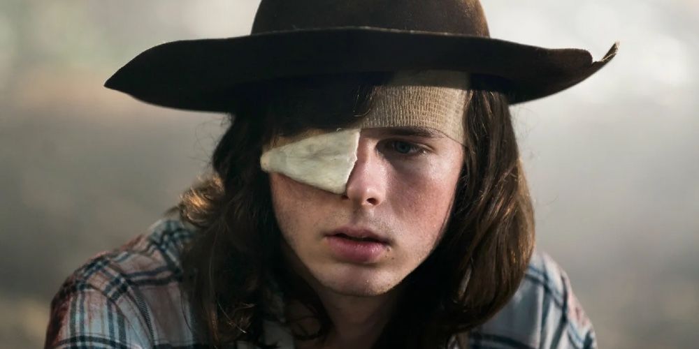 Carl Grimes with a cowboy hat on and a bandage on his eye in The Walking Dead