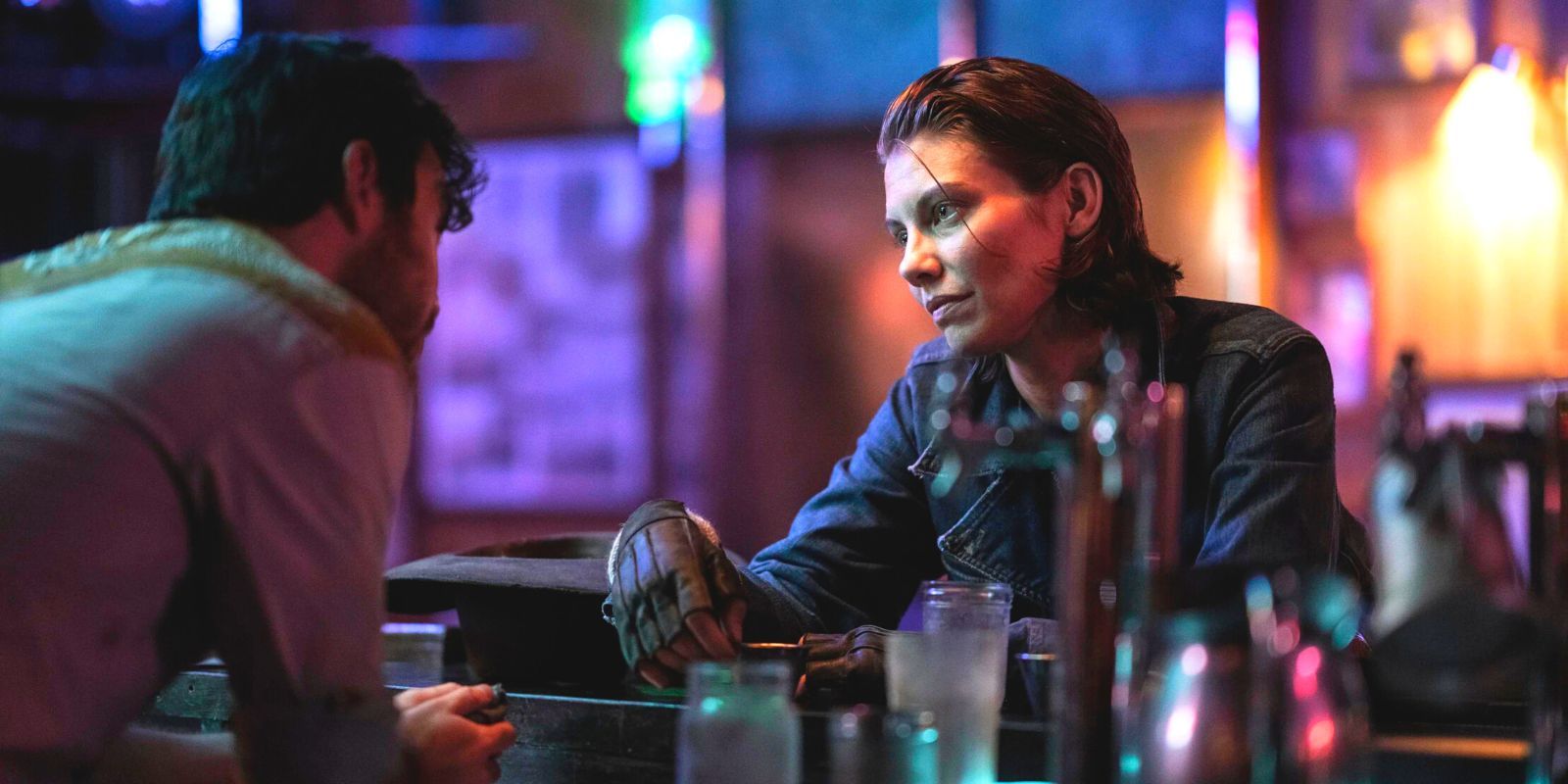 The Walking Dead's Maggie sitting at a bar while talking to the bartender