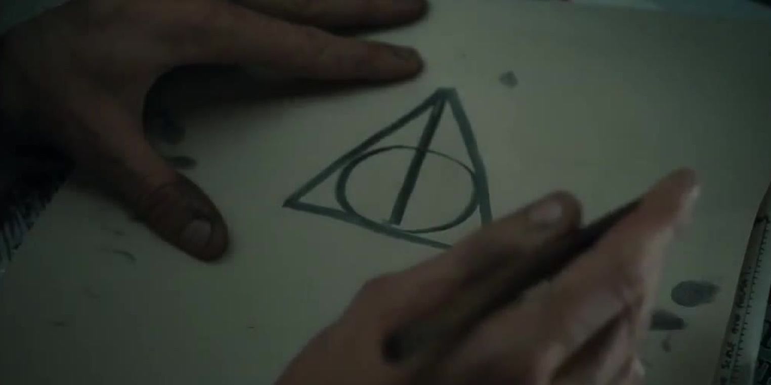 The Deathly Hallows symbol is drawn out with ink on a piece of paper