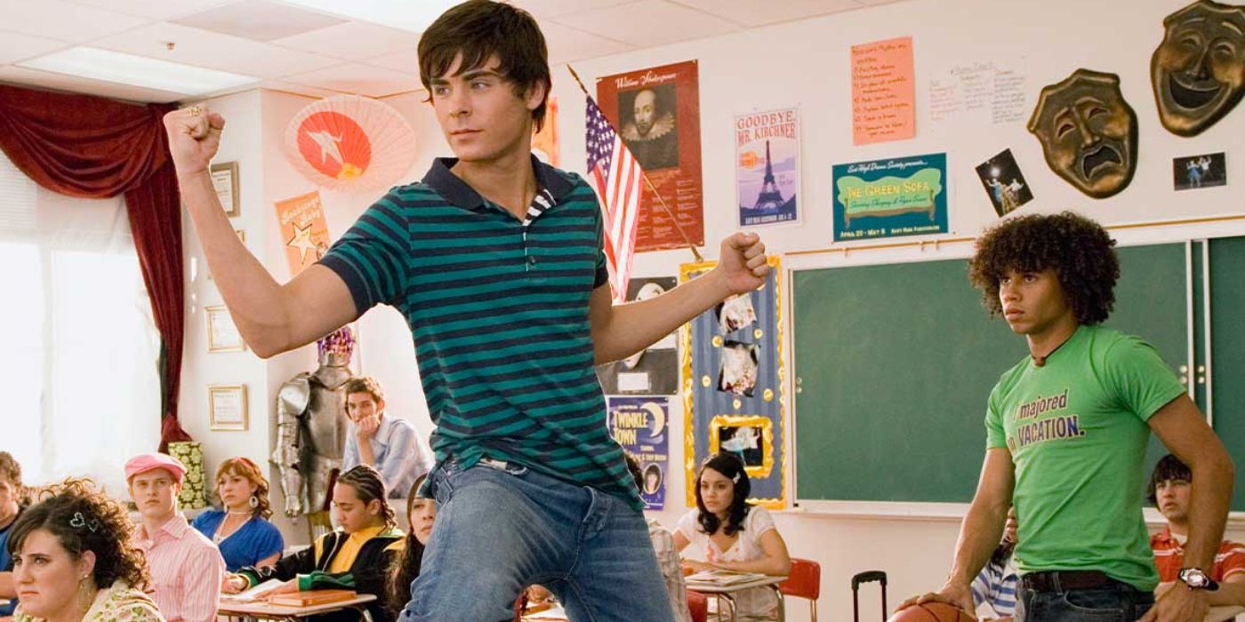 Zac Efron stands on his school desk in front of his class in High School Musical 2 