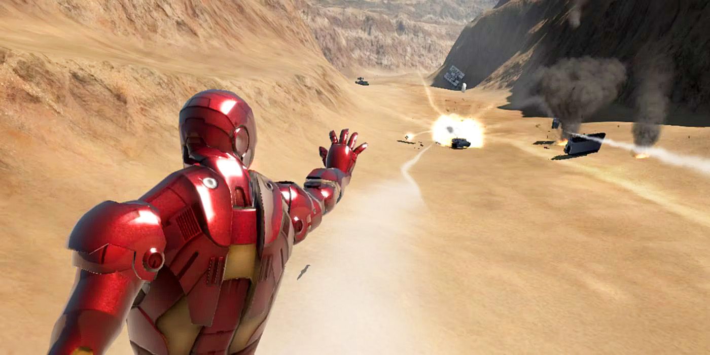 Game footage of Iron Man from behind, raising his right arm, blowing up enemy vehicles in the far desert background.