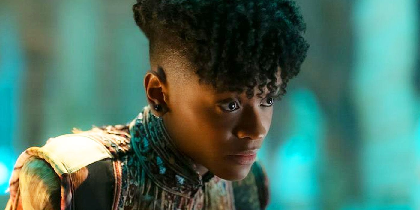 Letitia Wright as Shuri in a colorful uniform in Black Panther: Wakanda Forever looking concerned