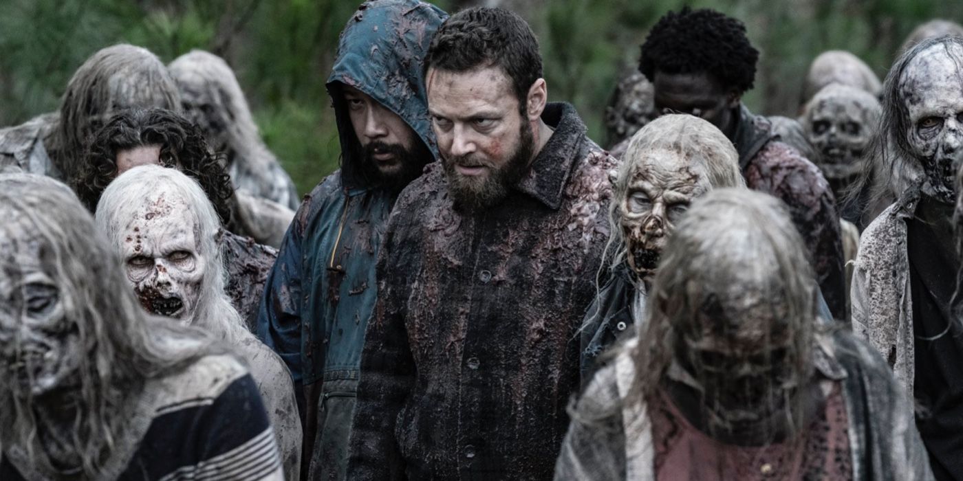 Aaron and Jerry disguising themselves as walkers in a horde on The Walking Dead.