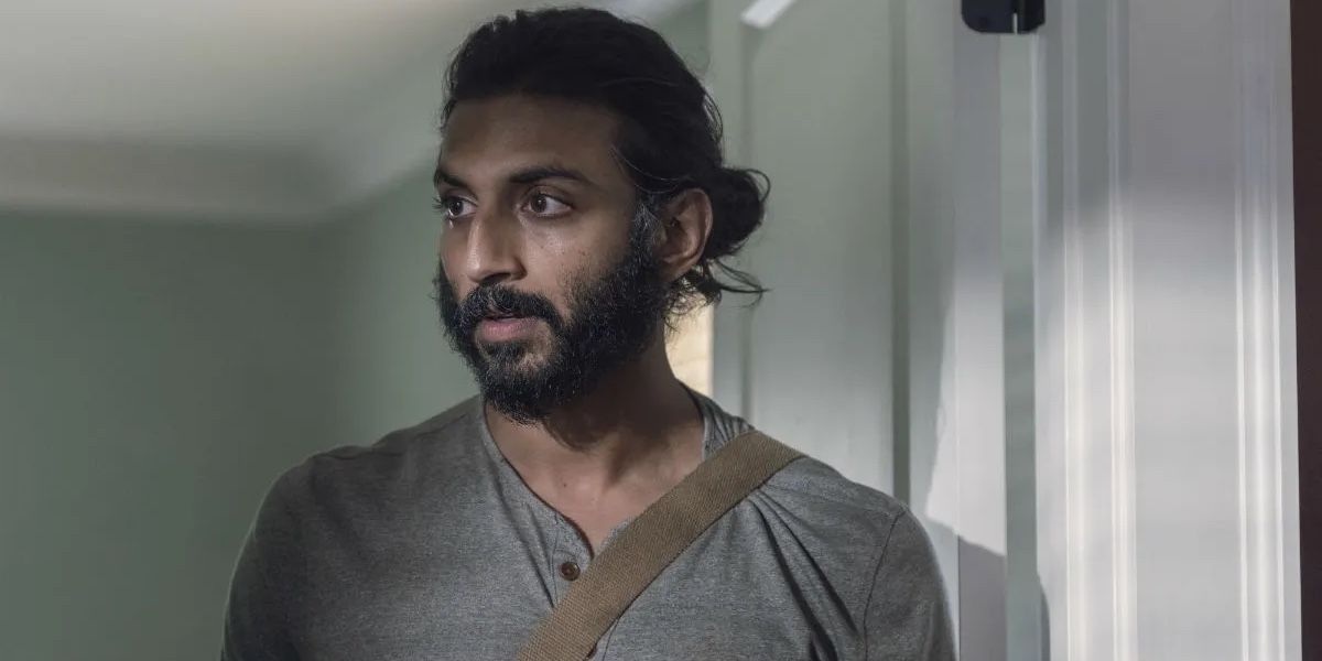 Siddiq looks to his right with mild surprise on his face in The Walking Dead