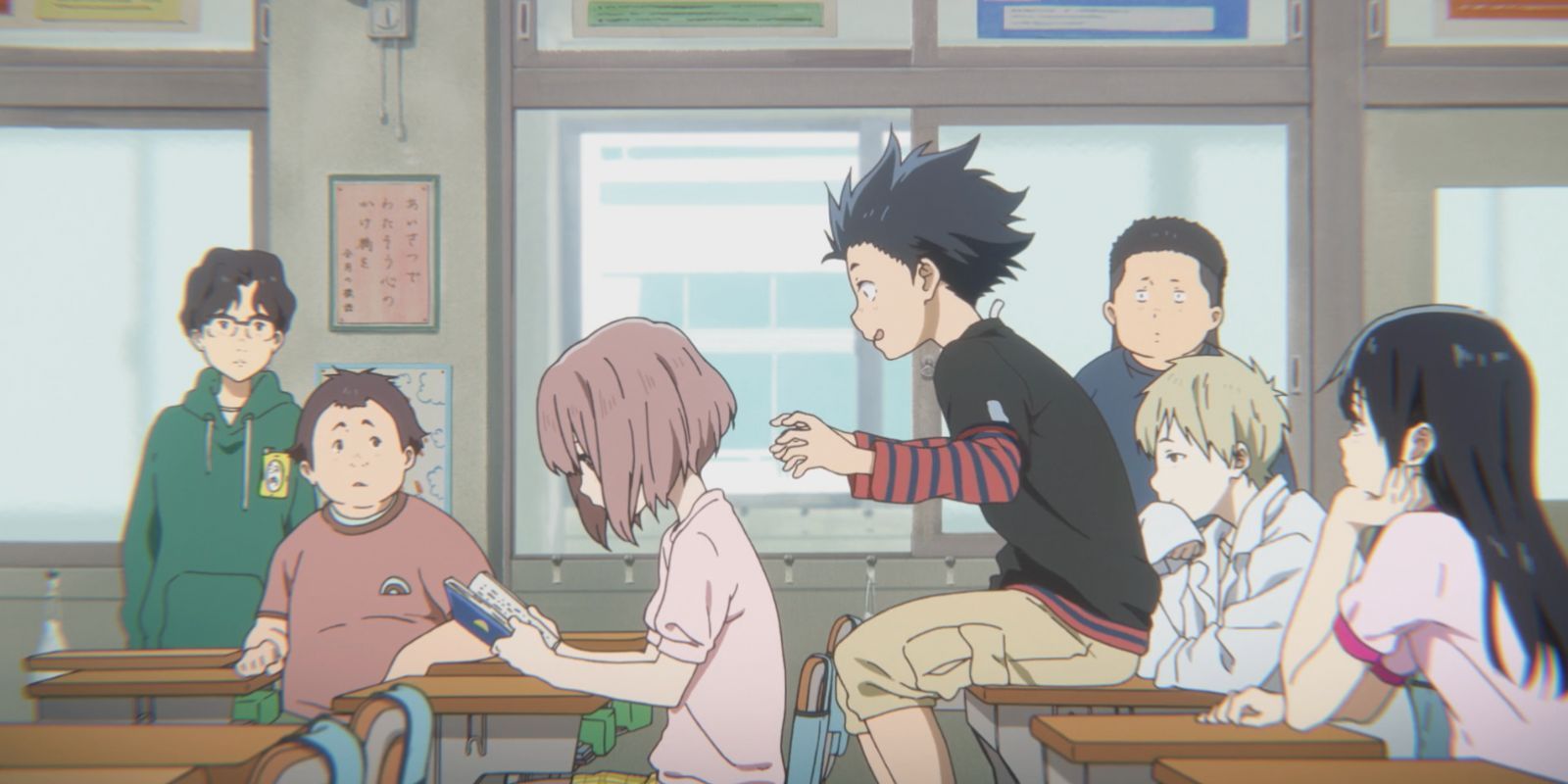 Young Shoya sitting behind young Shoko about to clap her ears in A Silent Voice.