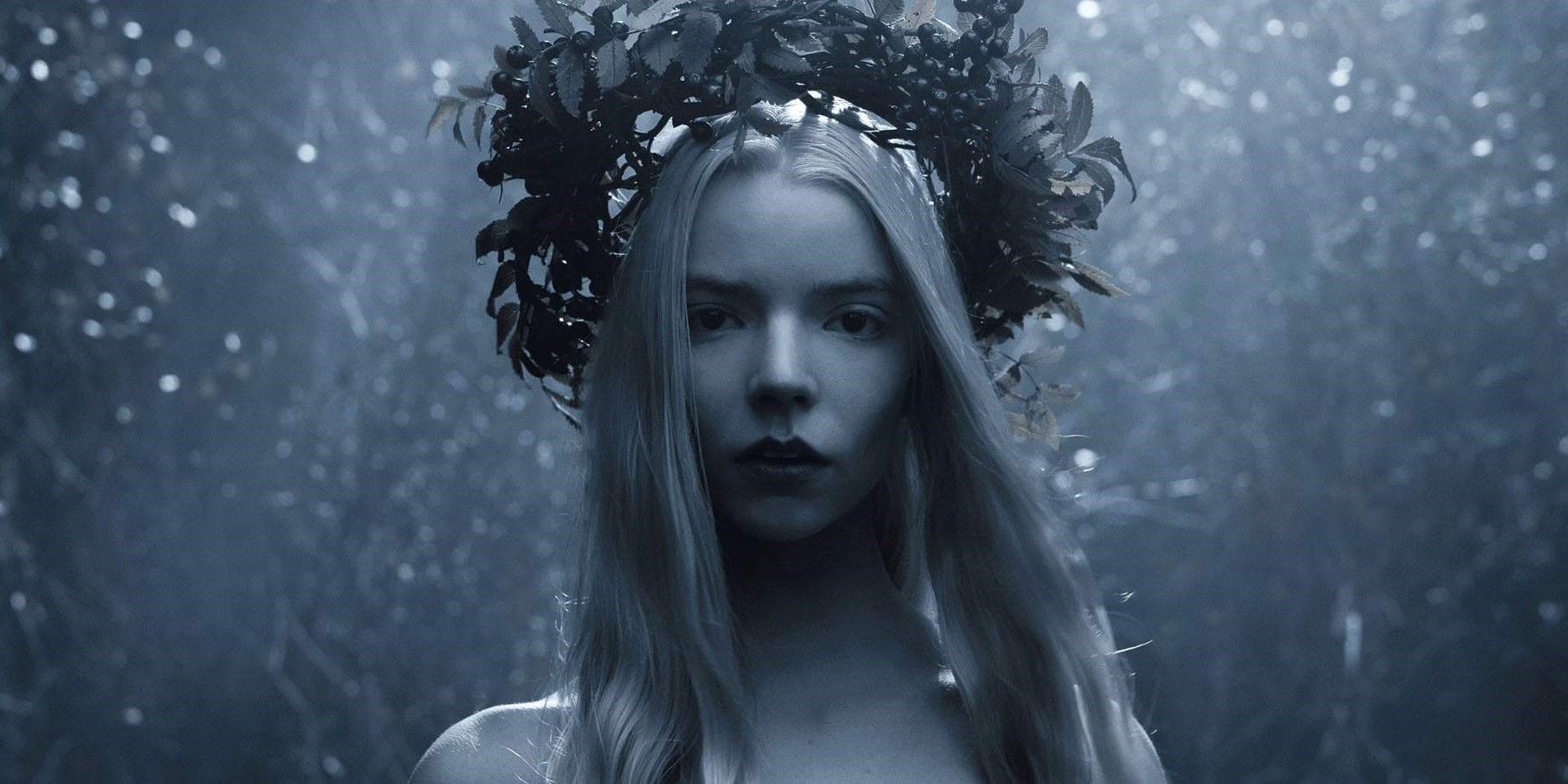 Surrounded by a forest, Olga (Anya Taylor-Joy) wears a makeshift crown in The Northman