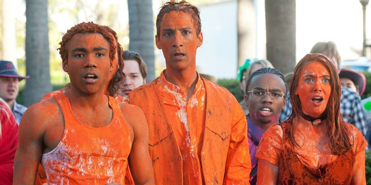 Community cast covered in orange paint