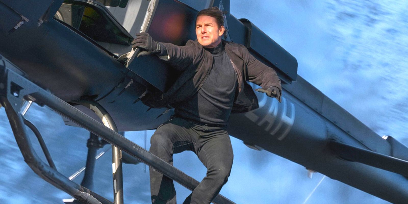 Tom Cruise dangling from the side of an airborne helicopter
