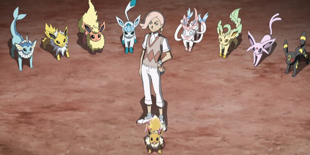 Ilima está rodeada por Eevee y cada Eeveelution en el anime Pokémon.