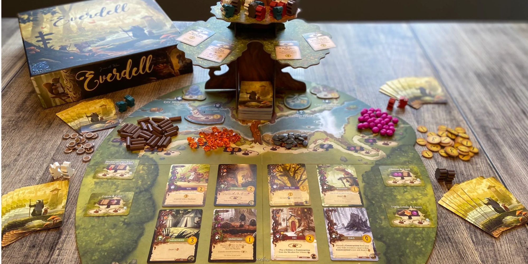 Everdell board game components laid out on a table.