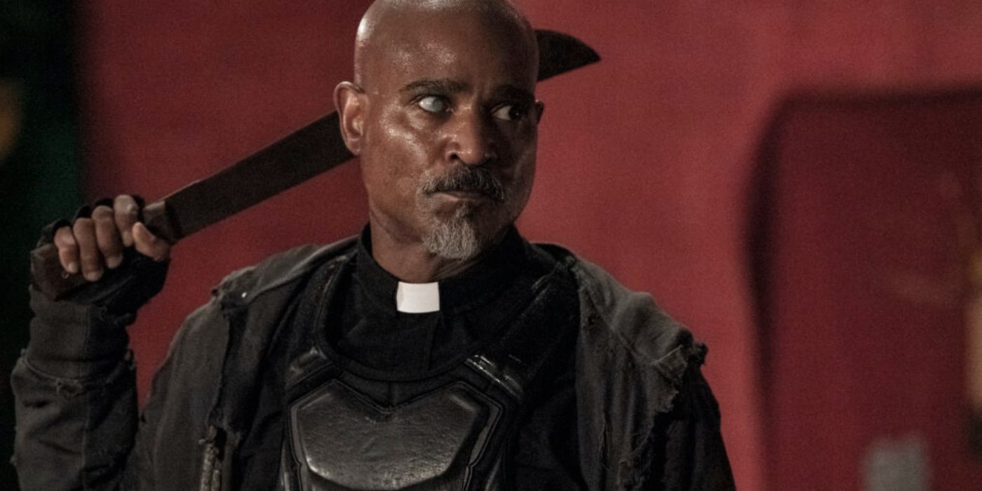 Gabriel Stokes holding a machete behind his head in The Walking Dead. 