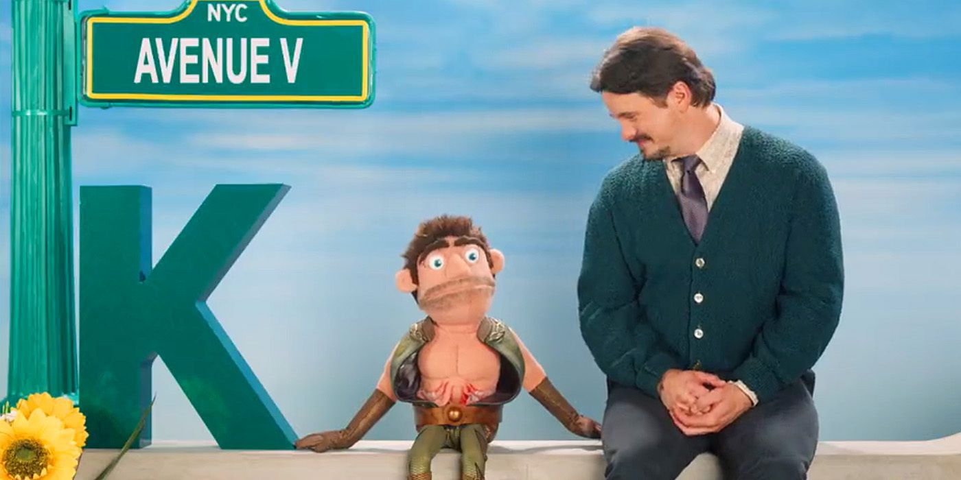 Jason Ritter dressed like Mr. Rogers with a puppet version of The Deep in a scene from Gen V.