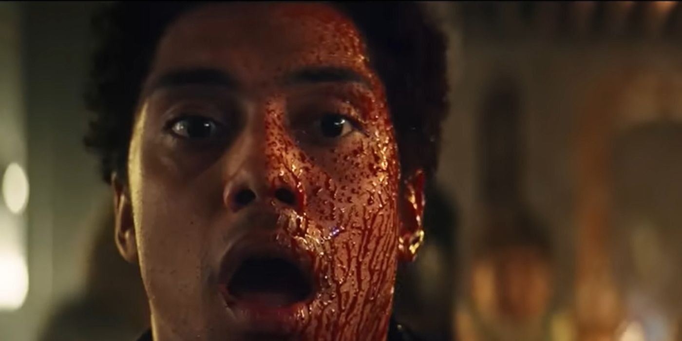 Close up of a young man from Gen V, his mouth open, blood covering his face.