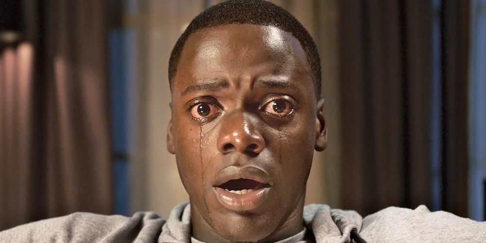 Daniel Kaluuya as Chris Washington looking shocked with tears falling in Get Out