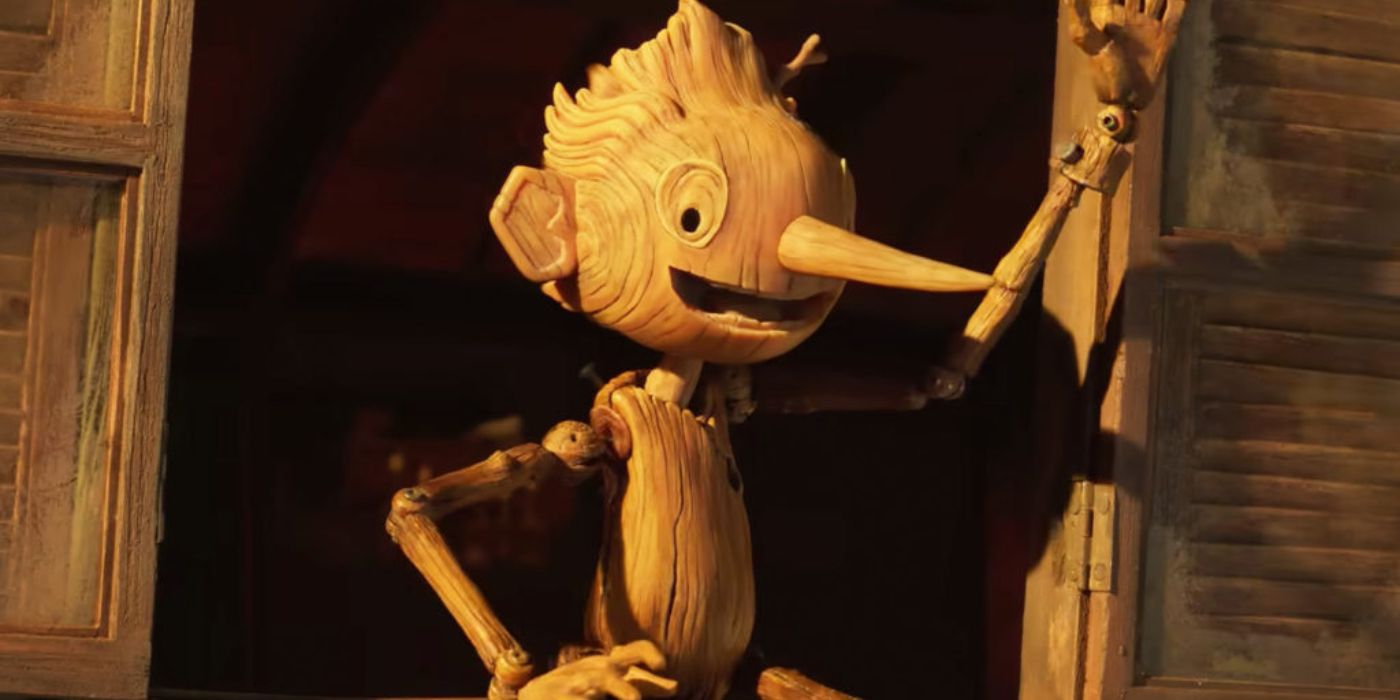 Guillermo del Toro's Pinocchio waving from a cart.
