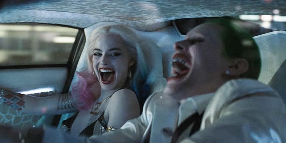 Harley Quinn and Joker laugh in their car in Suicide Squad 