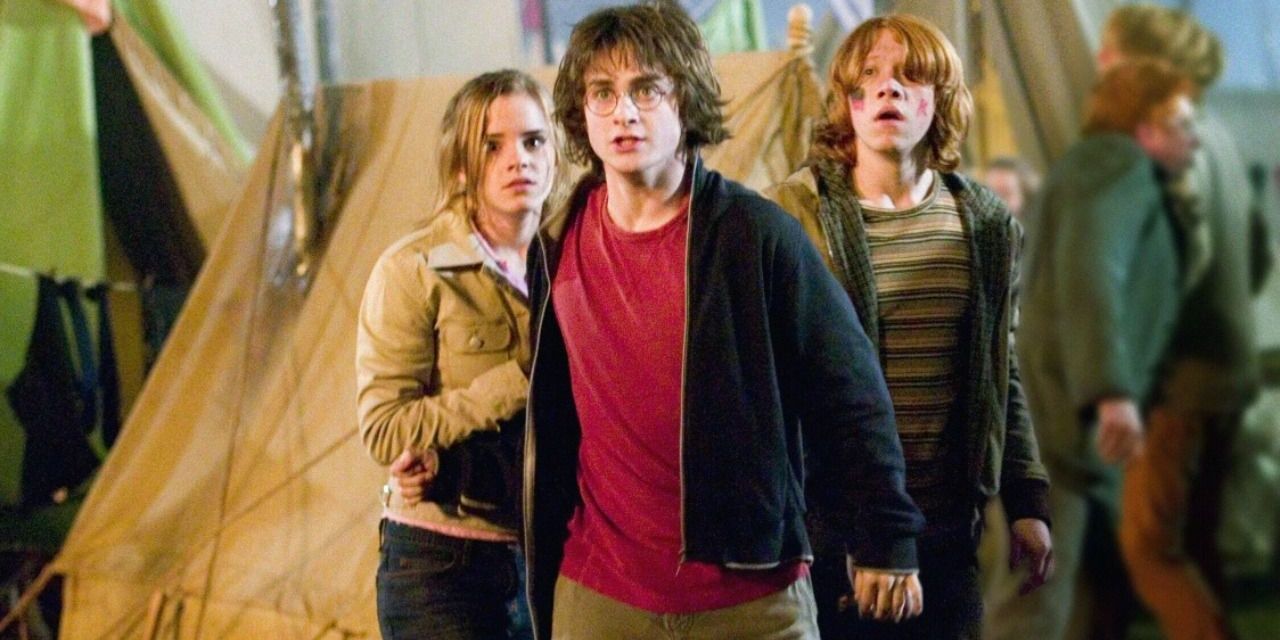 Harry, Ron, and Hermione looking scared by a tent in Harry Potter and the Goblet of Fire.