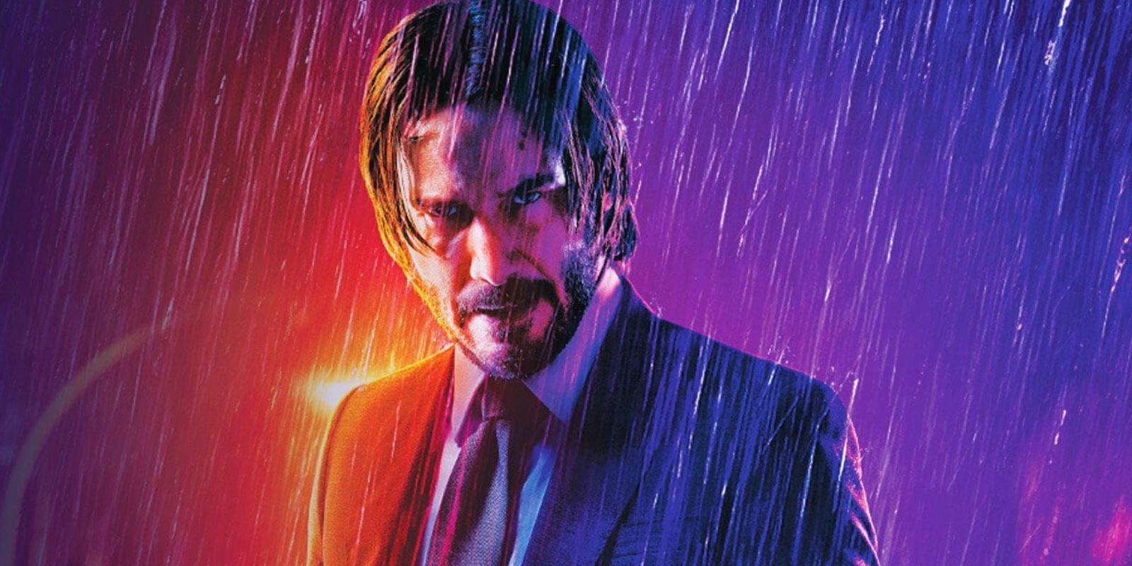 John Wick in a suit and tie standing in the rain