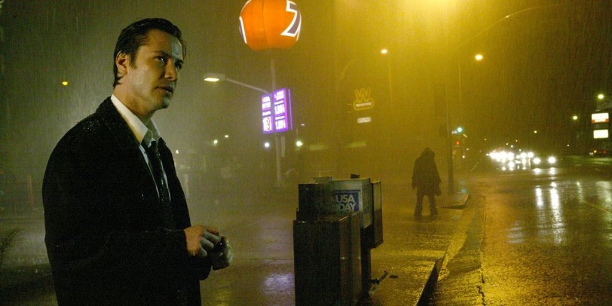 Keanu Reeves on a dark, rainy Los Angeles street in the 2005 film Constantine.