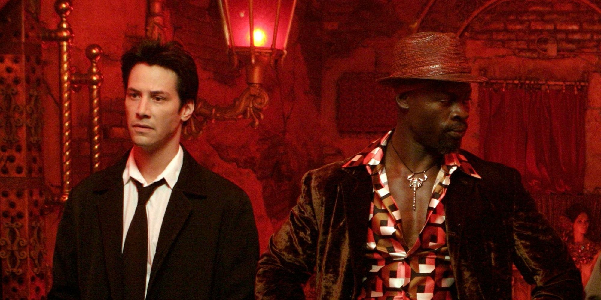 Keanu Reeves standing next to Djimon Hounsou in the 2005 film Constantine.