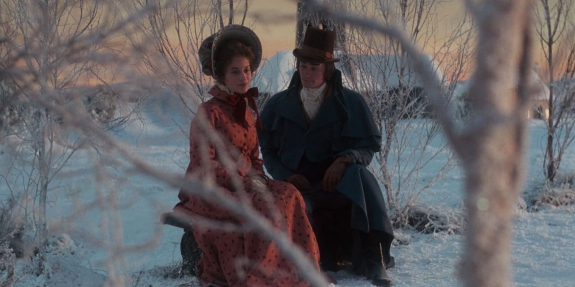 Belle and the younger Scrooge sit together in the woods in The Muppet Christmas Carol.