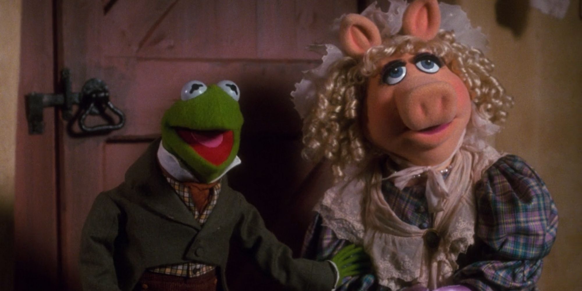 Kermit as Bob Cratchit and Miss Piggy as Emily Cratchit in The Muppet Christmas Carol.