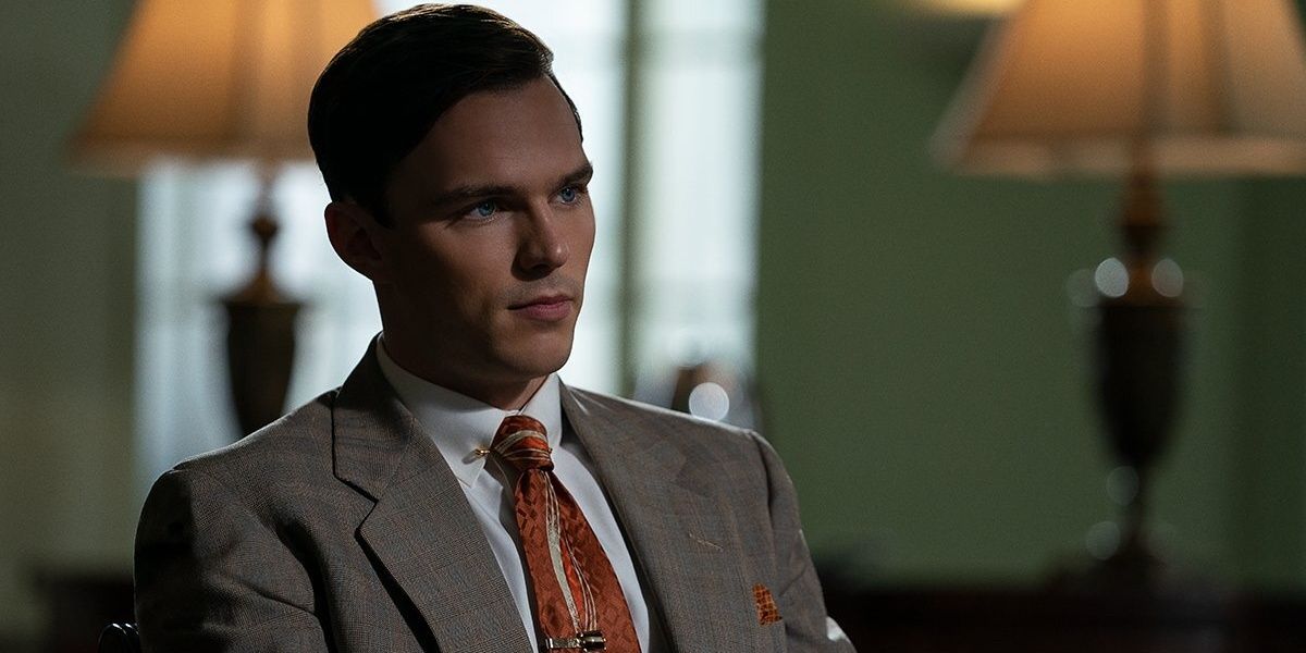 Nicholas Hoult wearing a suit in The Banker 