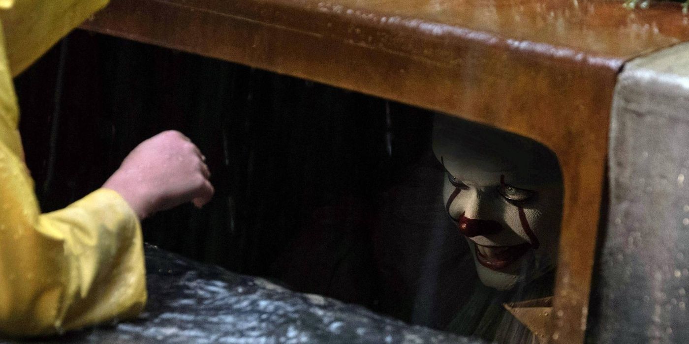 Pennywise talking to Georgie Denbrough from a storm drain in IT: Chapter One