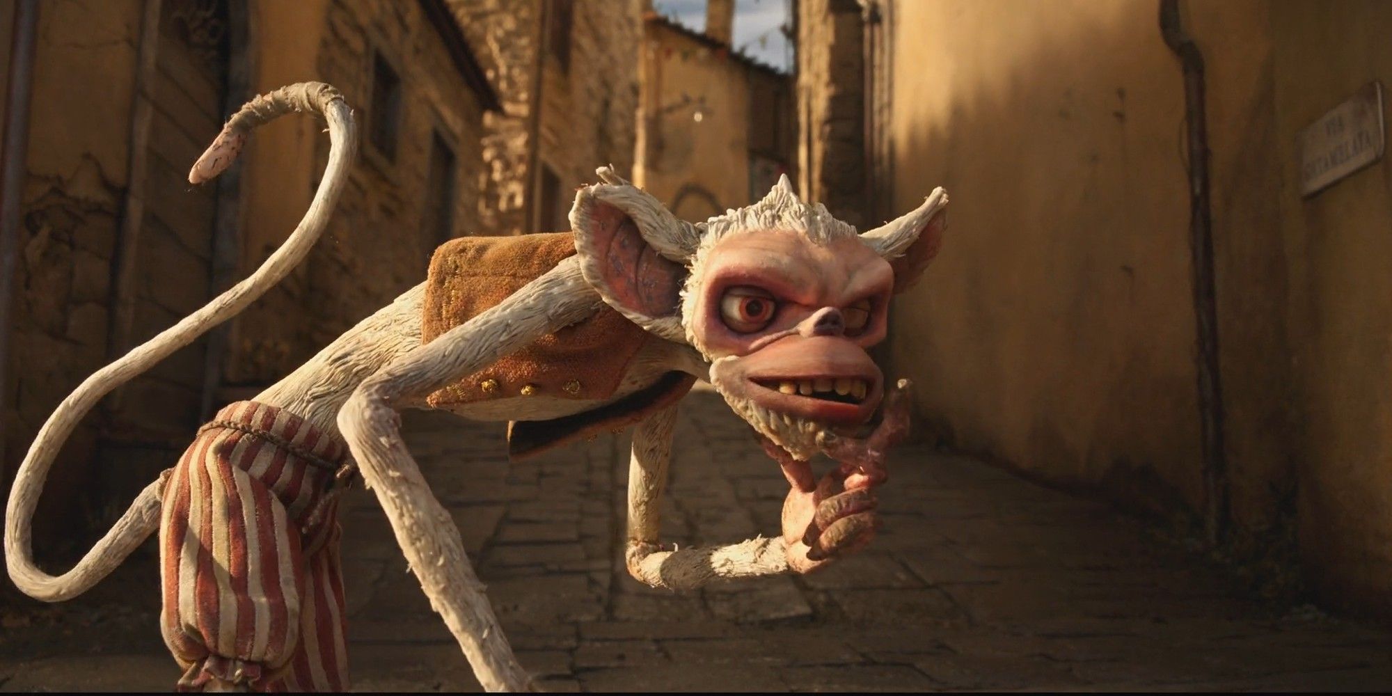 Spazzatura the monkey gives a mischievous look in Guillermo del Toro's Pinocchio