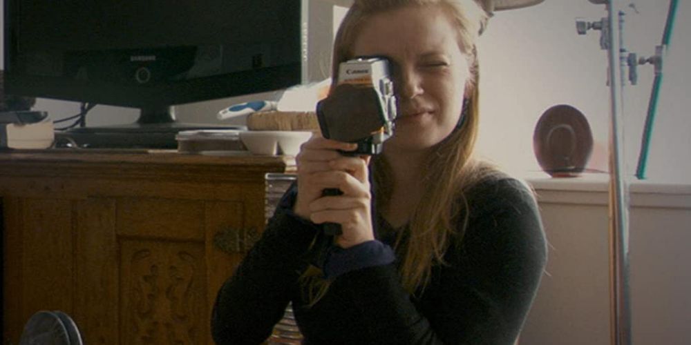 Sarah Polley holds a camera in Stories We Tell
