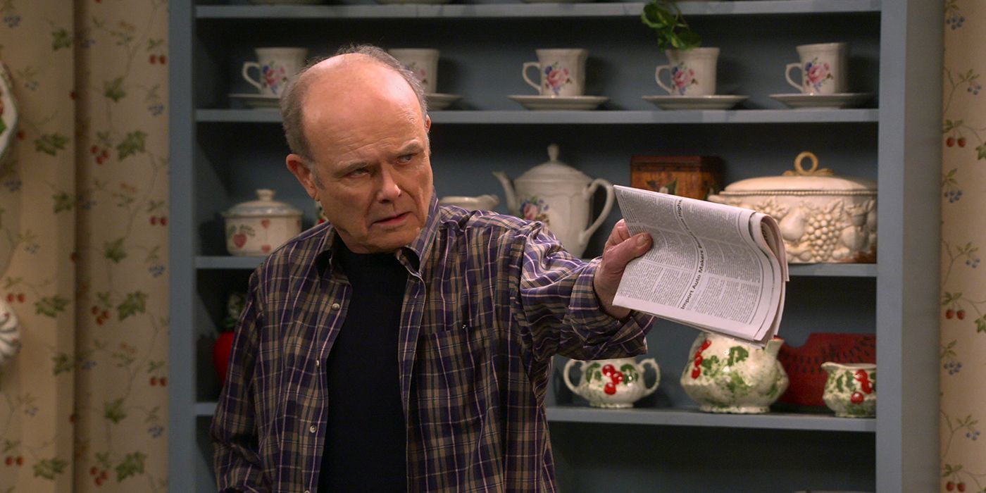 Red in That '90s Show pointing a newspaper at someone sternly.