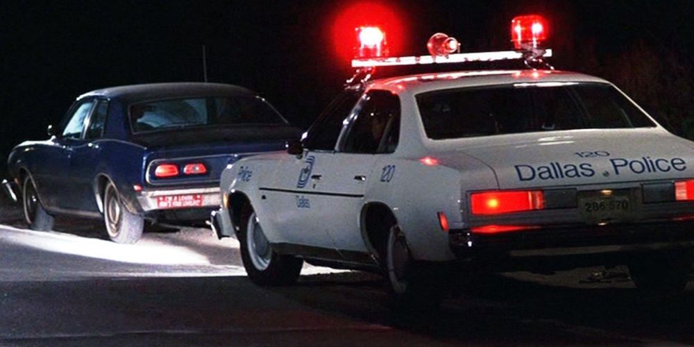 A police car pulls over a blue sedan in the documentary Thin Blue Line