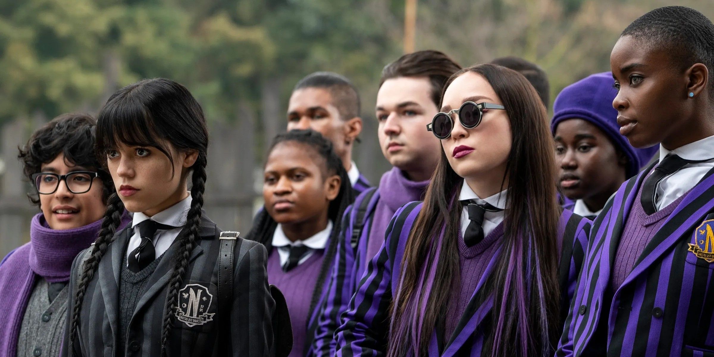 Jenna Ortega as Wednesday Addams with the whole team of outcasts in Wednesday.