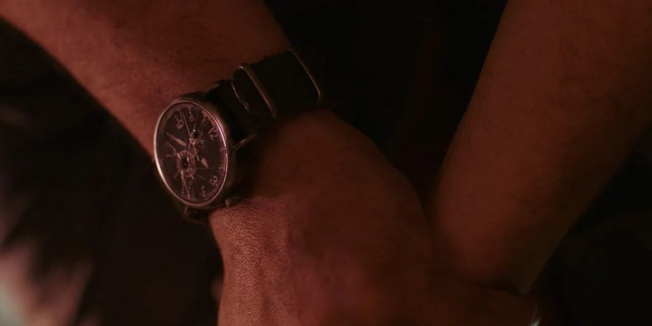 A close up of Joel wearing a broken watch in The Last of Us 