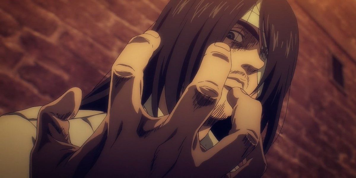Eren ominously looks at his hand in Attack on Titan.