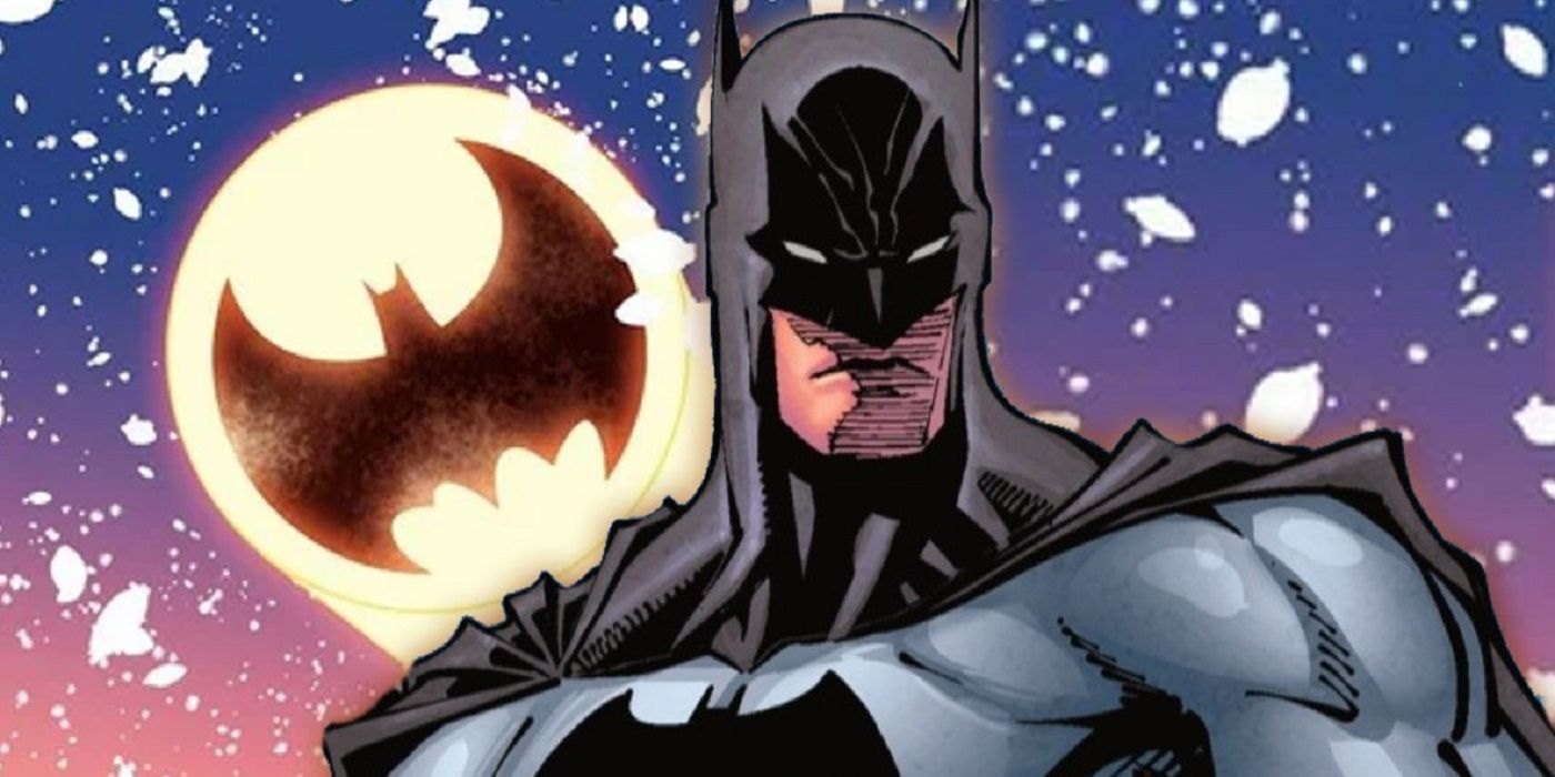 Batman in front of the Bat-Signal and snow