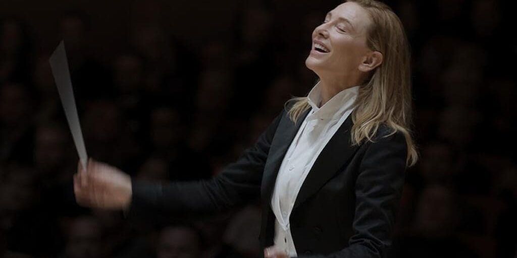 Cate Blanchett laughs while conducting in Tár 