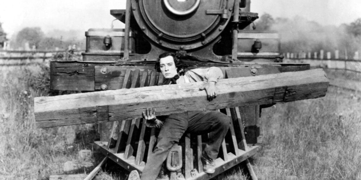 Buster Keaton holds a plank while resting on a train in The General